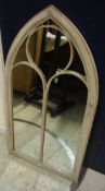A tall arched outdoor mirror