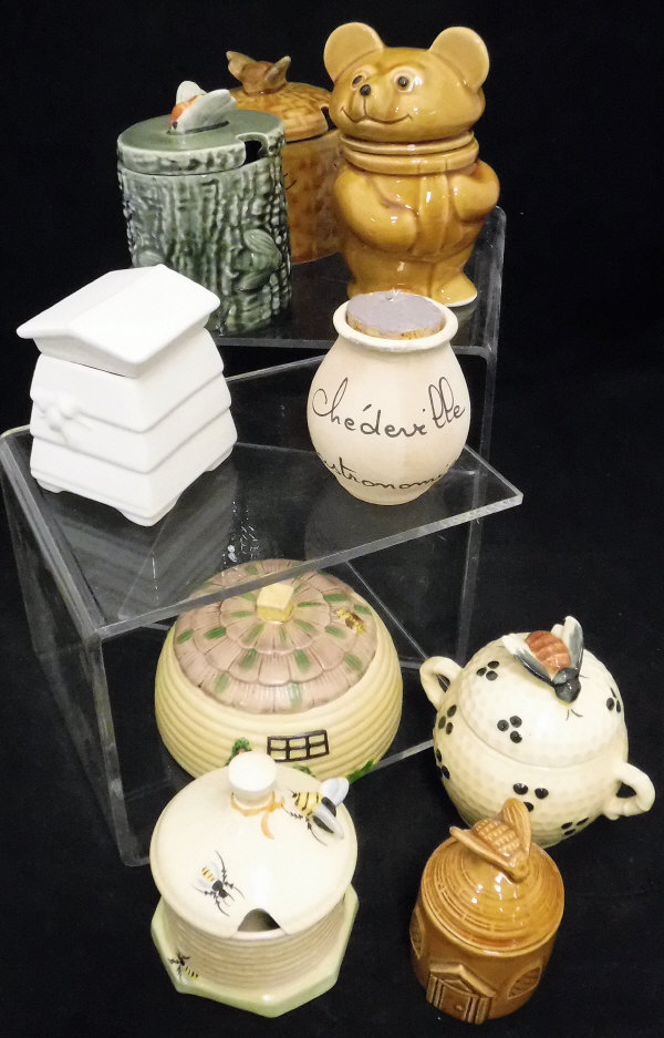 A quantity of assorted honey pots to include a Davenport Imari patterned example and a Crown Devon