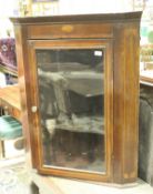 A 19th Century mahogany and inlaid hanging corner cupboard,