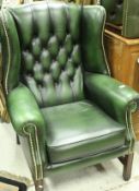 A pair of modern green leather button and studded wing back scroll arm chairs in the George III