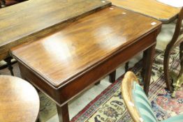 A 19th Century mahogany fold-over tea table raised on square chamfered supports