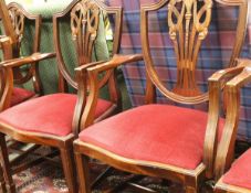 A set of seven modern mahogany dining chairs in the Chippendale style