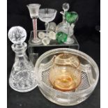 A large collection of cut glassware, including champagne glasses, green coloured sherry glasses,