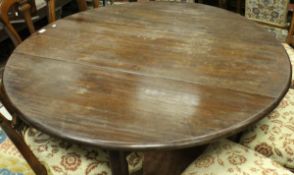 A 19th Century mahogany oval drop-leaf dining table on turned tapering legs to pad feet