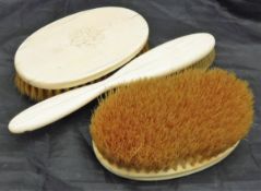 Three ivory backed dressing table brushes