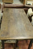A circa 1900 oak farmhouse style kitchen table with single frieze drawer on square tapered legs