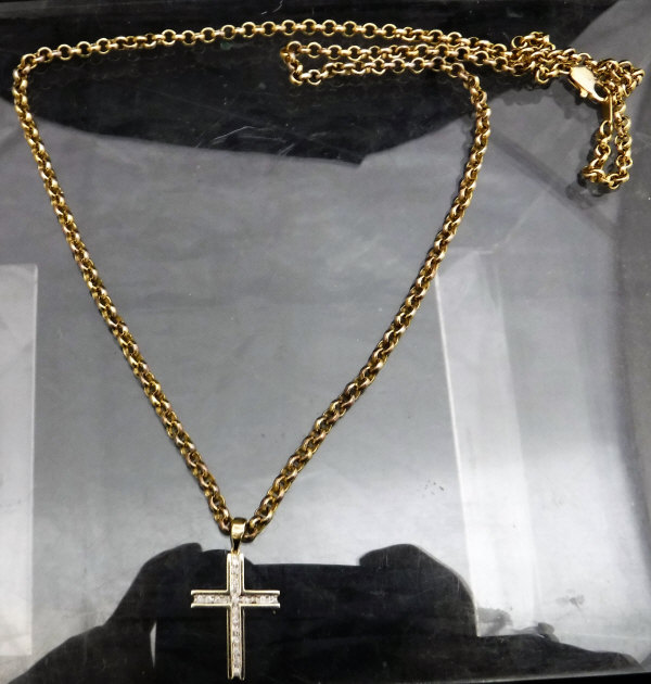 A 9 carat gold and chip diamond cross on a yellow metal chain, 16.