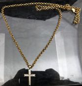 A 9 carat gold and chip diamond cross on a yellow metal chain, 16.