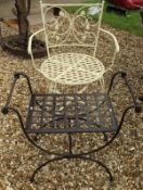 A modern painted metal garden chair with lattice and floral decoration,