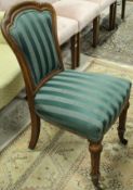 A set of four Victorian oak framed dining chairs with upholstered backs and seats on turned and