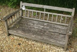 A teak garden swing seat