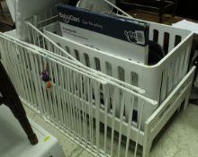 A modern white cot, together with a white toddlers bed, baby playpen, baby gate,