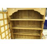 A modern pine dresser top, together with a modern pine four tier free standing bookcase,