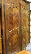 A 19th Century French fruitwood armoire with two door enclosing a hanging space