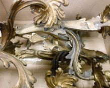 A set of four 20th Century gilt brass twin branch wall sconces in the Louis XV Rococo taste
