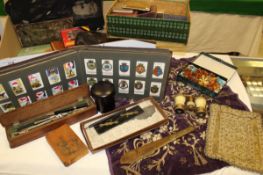 A pair of opera glasses and a pair of binoculars, amber necklace, assorted books, a powder compact,