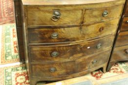 An early 19th Century mahogany bow fronted chest of two short over three long graduated drawers to
