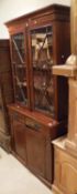 A 19th Century mahogany and satinwood banded bookcase cabinet with two astragal glazed doors
