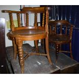 Three oak and elm bow back smokers chairs with carved backs and bobbin turned supports above a