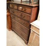 An oak and cross banded chest of two short over four long drawers to bracket feet