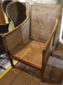 A circa 1900 mahogany framed bergere chair with cane back seat and sides