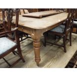 A Victorian pine extending dining table raised upon four turned supports to brown china castors