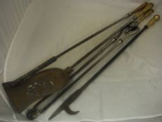 Three fire irons with brass embossed leaf decorated handles,