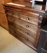 A 19th Century mahogany chest of drawers with a cushion drawer over two short and three long flame
