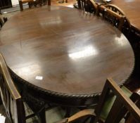 An Edwardian oval mahogany extending dining table,