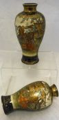 A pair of Japanese Meiji Satsuma ware vases decorated with various scenes and figures in panels,