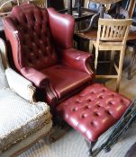 A red leather wing button back and studded arm chari and matching foot stoool raised upon cabriole