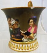 A Continental cabinet cup with painted decoration in the manner of Teniers of a girl reading a book