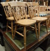 A modern pine farmhouse style kitchen table and a set of six modern beech stick back chairs