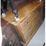 A pine chest of four assorted drawers raised upon a plinth base