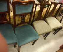 A pair of walnut framed dining chairs with turquoise upholstered seats and backs,