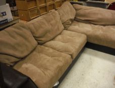A brown leatherette and suede effect corner sofa and pouffe
