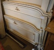 A circa 1900 French Louis XVI style double bed frame with painted cream with gilt hightlights