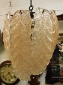 Ceiling light with eight peach tinted, frosted glass drops in the form of leaves.