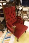 A Victorian salon chair with carved back and red velvet upholstery,