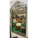 A rectangular mirror with etched and bevelled glass frame with floral decoration,