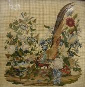 A Victorian needlework study in silk of a golden pheasant drinking water amongst foliage