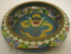 A Chinese cloisonné bowl decorated with dragon to the central blue ground field surrounded by a