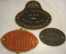 Three cast iron signs to include "Woods Cocksedge & Co A Royal Prize Stowmarket",
