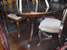 A late Georgian mahogany oval drop-leaf dining table on turned and cabriole legs to pad feet,
