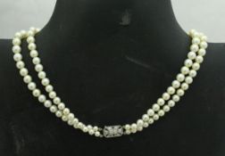 A two strand pearl necklace with diamond set clasp CONDITION REPORTS Smallest pearl