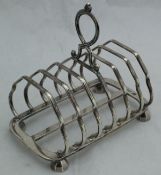An Edwardian silver six section toast rack (by Pearce & Sons, Sheffield 1907), 11.