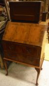 A modern yew wood bureau, a walnut cased Singer sewing machine,
