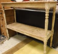 A pine two tier hall table on turned supports to white china castors