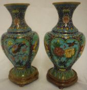 A pair of Chinese cloisonné vases of lobed form decorated with dirds amongst flowers raised upon