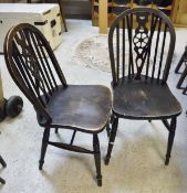 A set of fifteen wheel back dining chairs